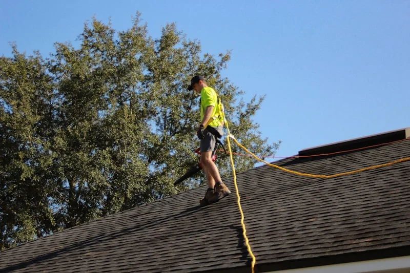 A roofer at work on a finished roof